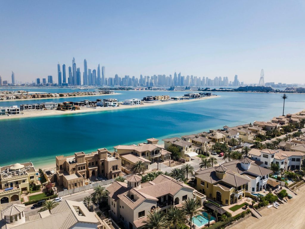 A breathtaking aerial view of Dubais skyscrapers and luxury villas on a sunny day.